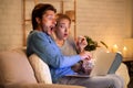 Surprised Couple Watching Film On Laptop Sitting On Sofa Indoor Royalty Free Stock Photo