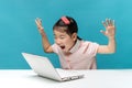 Surprised, Cute asia little girl who enjoy the laptop computer o Royalty Free Stock Photo