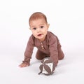 Surprised baby boy crawling with ball Royalty Free Stock Photo