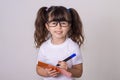 Surprised cute child writing in notebook using pencil, keeping mouth wide open. Four or five years old kid, isolated