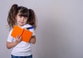 Surprised cute child writing in notebook using pencil, keeping mouth wide open. Four or five years old kid, isolated