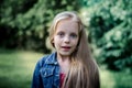 Surprised cute little blond girl at summer field. Royalty Free Stock Photo