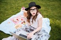 Surprised cute young woman using laptop on picnic Royalty Free Stock Photo