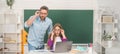 surprised dad and daughter near clackboard. back to school. childhood education.