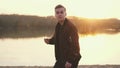 Surprised emotional man looking into the camera. Portrait of a handsome young guy on the beach during sunset Royalty Free Stock Photo