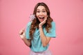 Surprised emotional young woman holding magically stick star