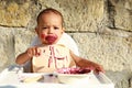 Surprised essy baby boy eating blueberry cake Royalty Free Stock Photo