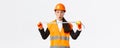 Surprised and excited asian female construction engineer, industrial worker in safety helmet and uniform, measuring Royalty Free Stock Photo