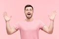 Surprised excited man portrait with arms raised