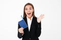 Surprised excited pretty businesswoman holding tickets and passport