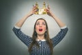 Surprised woman with golden crown. First place concept. Royalty Free Stock Photo