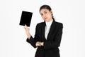 Surprised face of young Asian business woman in suit holding digital tablet in hands over white isolated background Royalty Free Stock Photo
