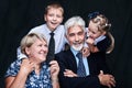 Surprised family posing together with open mouths showing playful and humorous expression