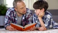 Surprised father and son astonished after reading new interesting information Royalty Free Stock Photo