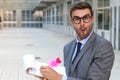 Surprised flamboyant businessman taking notes with a cute pink pen Royalty Free Stock Photo