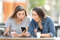 Surprised friends finding amazing phone online content