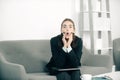 Surprised funny young secretary woman in a busy modern workplace in office. Pretty accountant girl at desk in office Royalty Free Stock Photo