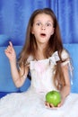 Surprised girl with apple Royalty Free Stock Photo