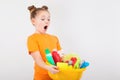 Surprised girl with a basin full of cleaners Royalty Free Stock Photo