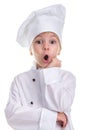 Surprised girl chef white uniform isolated on white background, looking straight at the camera, holding the hand under