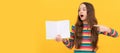 Surprised girl child point finger at open book for copy space yellow background, pointing. Banner of schoolgirl student Royalty Free Stock Photo