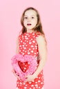 Surprised girl holding rosy heart on pink background Royalty Free Stock Photo