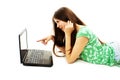 Surprised girl with laptop. Pointing at it Royalty Free Stock Photo