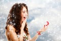 Surprised girl opening red gift box with engagement ring. Winter. Royalty Free Stock Photo
