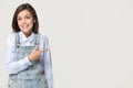 Surprised girl pointing finger at copy space isolated on background Royalty Free Stock Photo