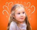 Surprised girl with a question marks Royalty Free Stock Photo