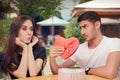 Surprised Girl Receiving Heart Shaped Gift from her Boyfriend Royalty Free Stock Photo