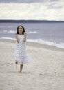 Surprised girl is running on the beach Royalty Free Stock Photo