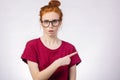 Surprised girl showing empty copy space with her finger white background Royalty Free Stock Photo