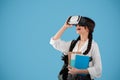 Surprised glad european teen girl student with pigtails and backpack in vr glasses hold books