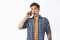 Surprised guy receive amazing news on phone call, calling someone and gasping amazed, astonished by news, having Royalty Free Stock Photo