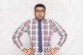 Surprised handsome bearded businessman in checkered shirt, blue