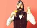 Surprised handsome bearded pilot on red studio background Royalty Free Stock Photo