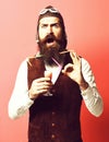 Surprised handsome bearded pilot on red studio background Royalty Free Stock Photo