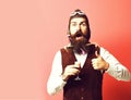 Surprised handsome bearded pilot on red studio background Royalty Free Stock Photo