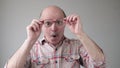 Surprised handsome senior man looking through glasses on shock content. Royalty Free Stock Photo