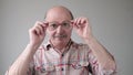 Surprised handsome senior man looking through glasses. Royalty Free Stock Photo