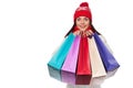 Surprised happy beautiful woman holding shopping bags in excitement. Christmas girl on winter sale, isolated on white Royalty Free Stock Photo