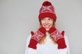 Surprised happy beautiful woman looking sideways in excitement. Christmas girl wearing knitted warm hat and mittens, isolated on Royalty Free Stock Photo