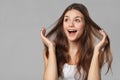 Surprised happy beautiful woman looking sideways in excitement. Isolated on gray background Royalty Free Stock Photo