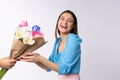 Surprised and happy caucasian girl receiving bouquet of flowers. Spring tulips, surprise your gift March 8 or