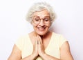 Surprised happy elderly woman looks down and laughing Royalty Free Stock Photo