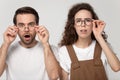 Surprised happy millennial man and woman looking closely at camera. Royalty Free Stock Photo