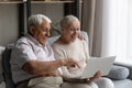 Surprised happy old family couple using computer. Royalty Free Stock Photo