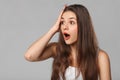 Surprised happy woman looking sideways in excitement, isolated on gray background Royalty Free Stock Photo