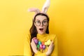 Surprised happy young woman in eyeglasses expresses shock, prepares for unforgettable spring holiday